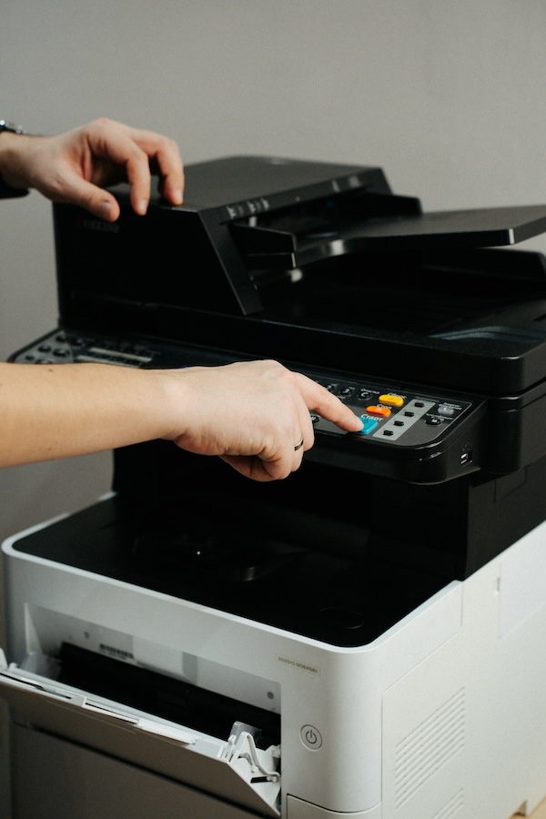 Hands using a multi-function printer